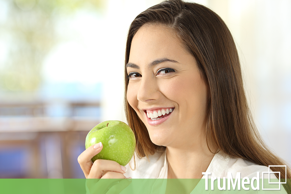 healthy young woman eating apple from Edmonton Naturopath